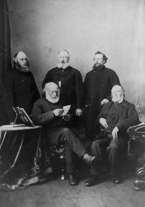 George Clark and his sons. Nicholas is sitting on the far right and John is standing on the far left.